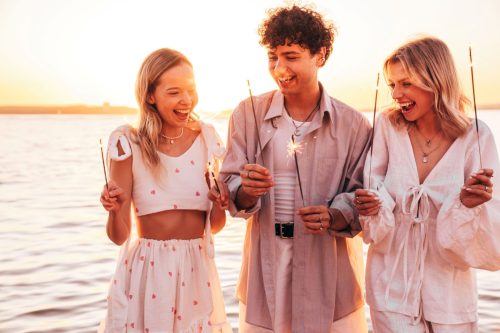 friends on beach at sunset