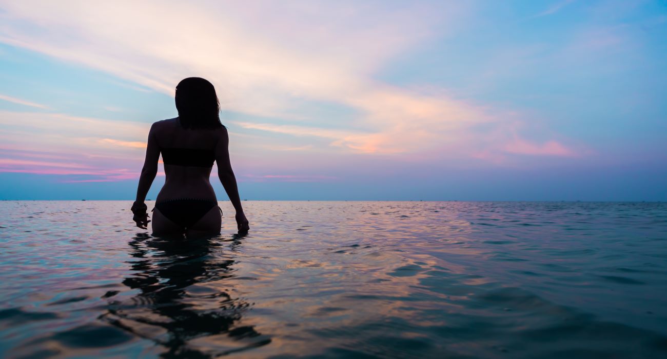 woman in dauphin island ocean water in the evening