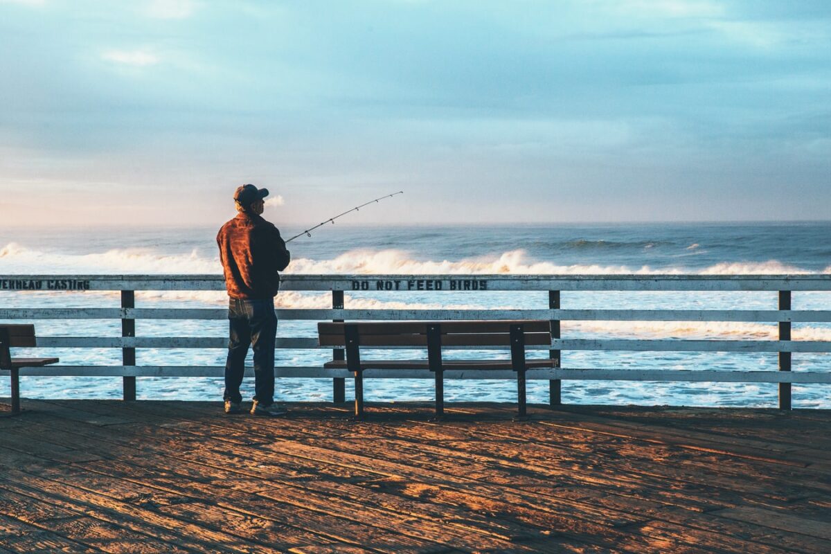 man fishing on a pier