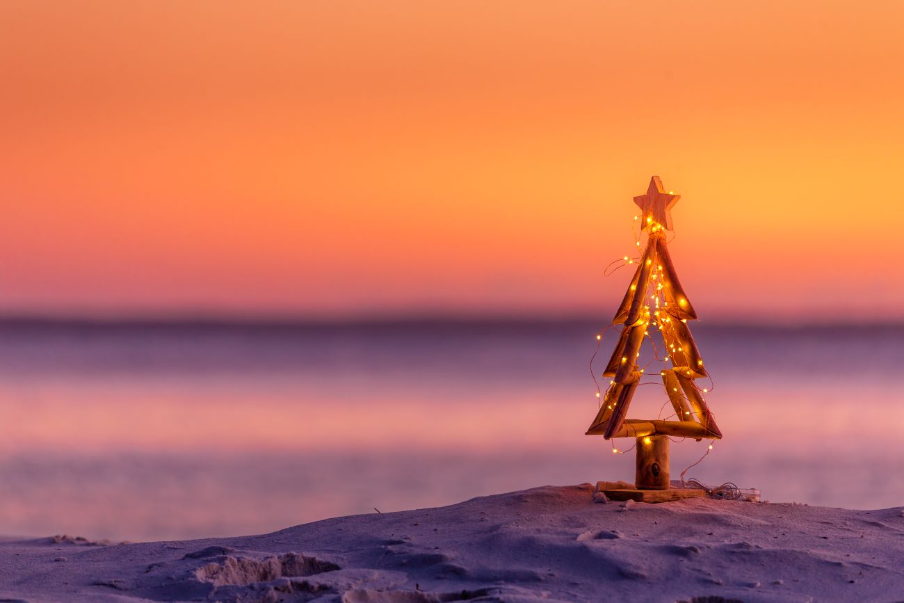 small wooden Christmas tree ornament on dauphin island beach
