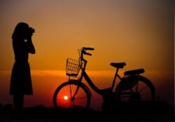 woman and bike at sundown on Dauphin Island