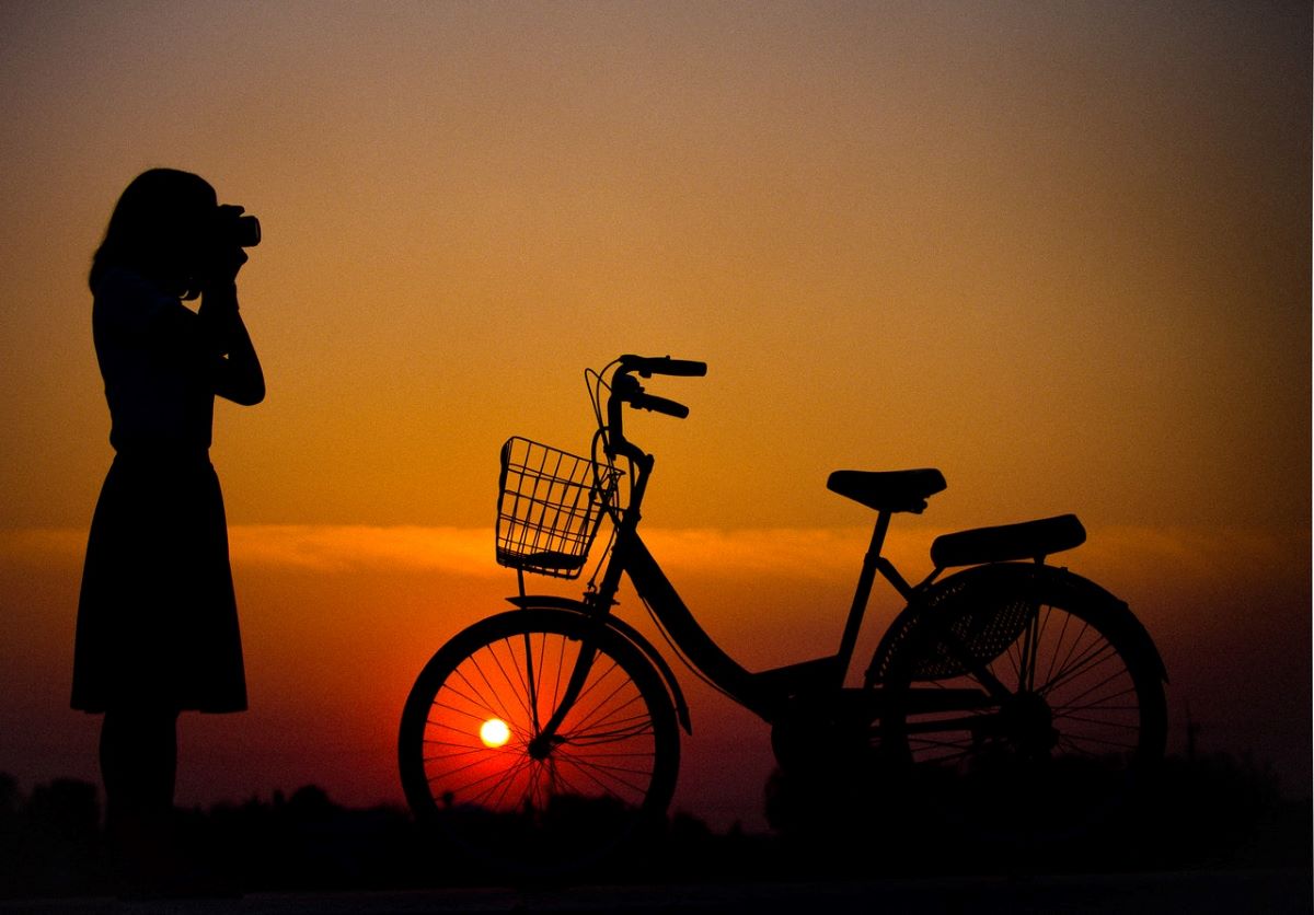 woman and bike at sundown on Dauphin Island