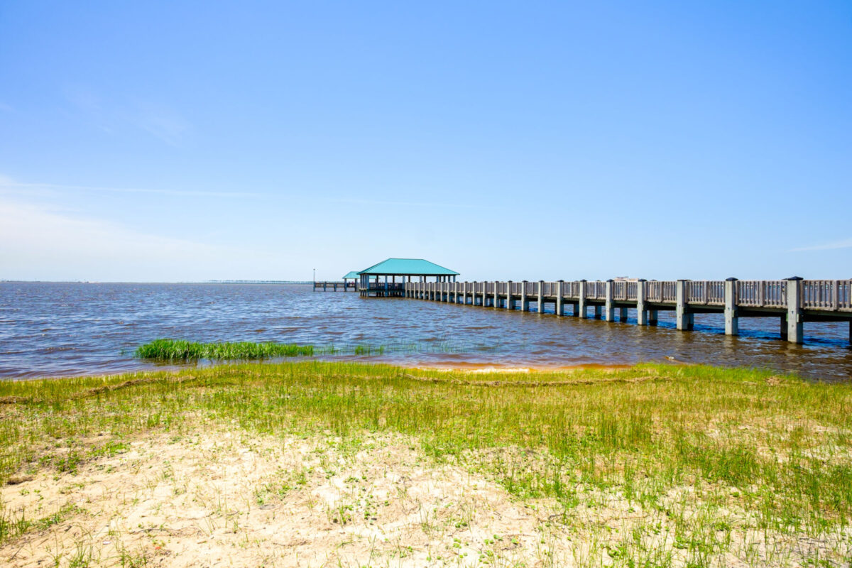 A pier extends in to the ocean.