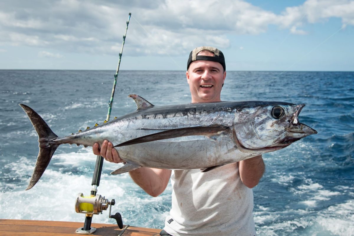 Guy holding up tuna