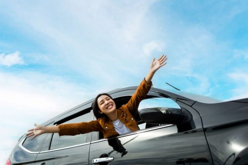 girl smiling out of car window